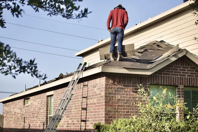Professional roofer working on a residential roof in Alexandria